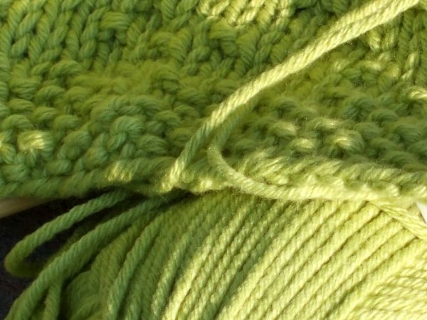 Close-up of the green Cotton Ease worked in seed stitch