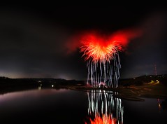Heart of Satan - What it looks like when fireworks explode inside of a storm cloud over a river - by Stuck in Customs