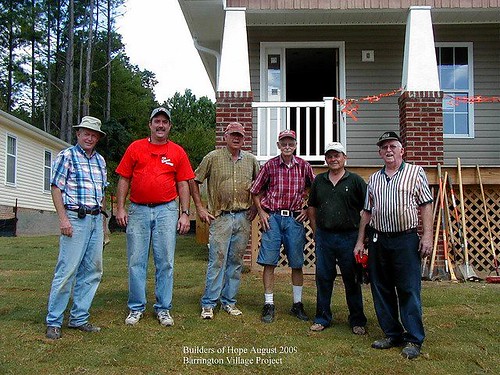 volunteers from Athens Drive Baptist Church in front of a home rehabbed by Builders of Hope (by: Builders of Hope)