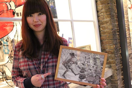 Chikako with her art with QOS lapel Cardigan