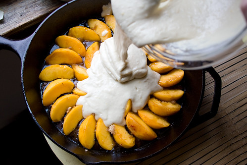 Pouring batter over peaches