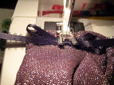 Sewing on some ribbon