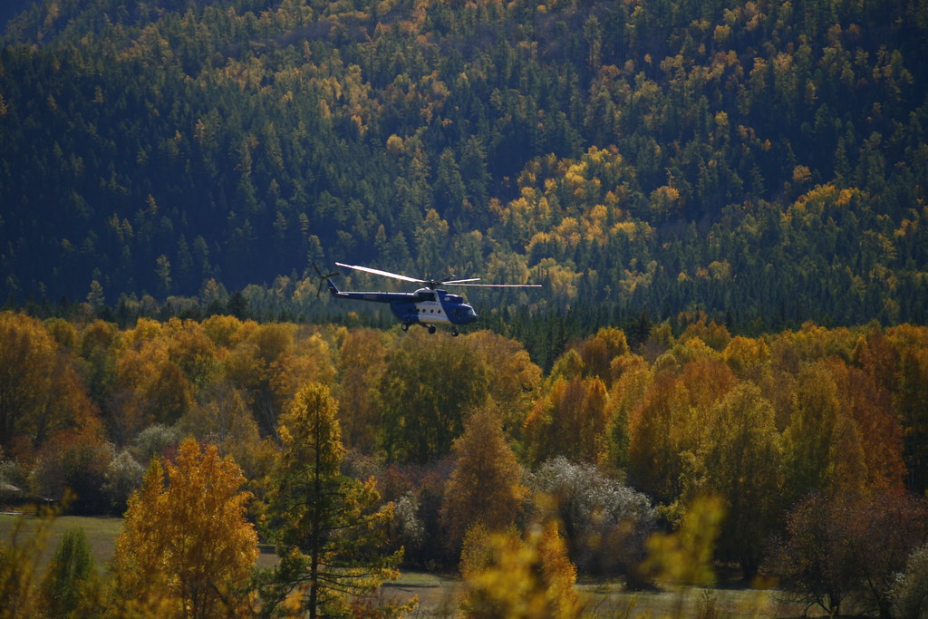 : Mi-8 over the valley. Altai mountains.