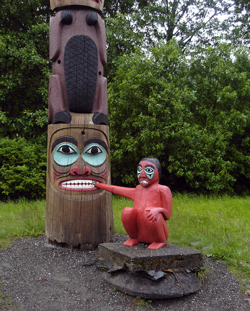 Boy Caught in Clam  (totem at Saxman, Alaska)