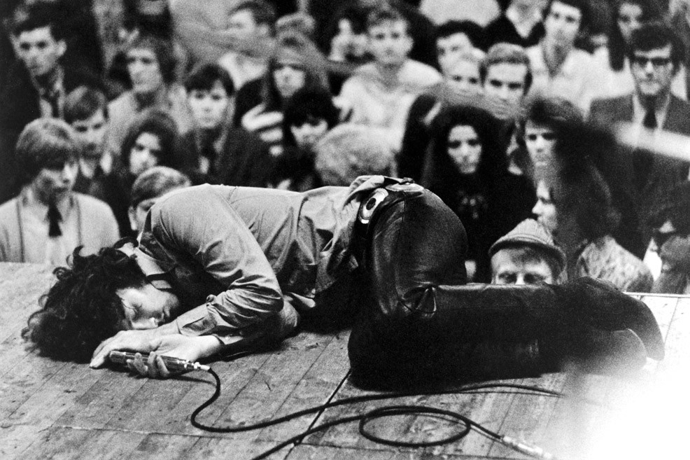 Sonic Editions - The Uncut Collection: Jim Morrison lies on stage during a concert