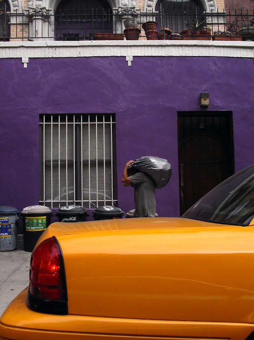 taxi and man carrying a bag