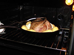 beef roasting with some potatoes and garlic