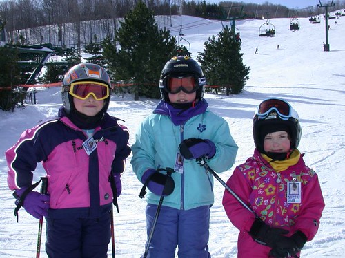 Caption: A group of young skiers pose for a photo in Blue Mountain, Ontario