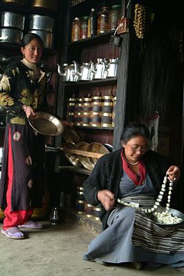 Tsering Futik Sherpa readies lunch while her mother weaves fresh churpis by Kashish Das Shrestha
