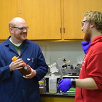 A professor talking with one of his students in the lab.