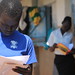 Students look at their report cards. Uganda