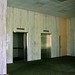 Tower lobby elevators with marble wall and drop ceiling