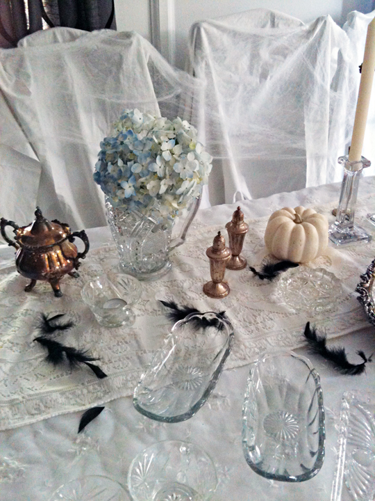 vintage crystal dishes+tarnished silver platters and tea set+blue hydrangeas+ghost table+halloween tabletop decorating ideas