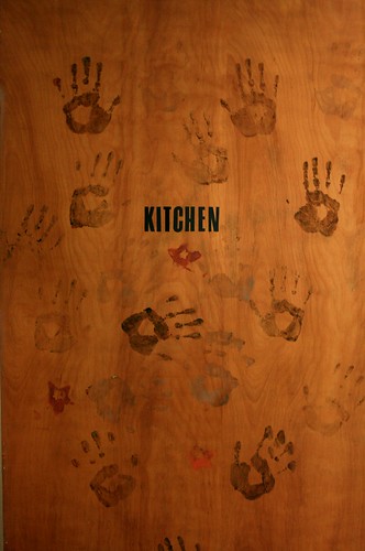 Camp House kitchen door with hand prints