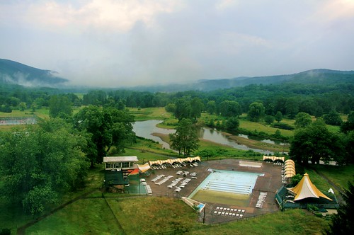 Hazy sky over outdoor pool and golf course