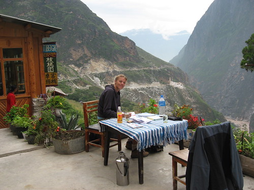 a woman sitting at a table on a mountain