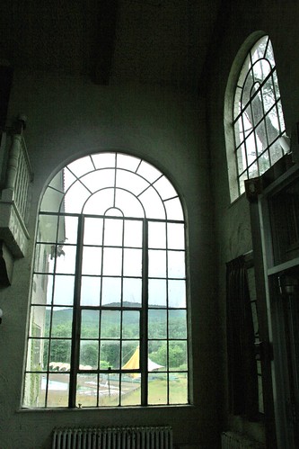 Outdoor pool seen through large arched window
