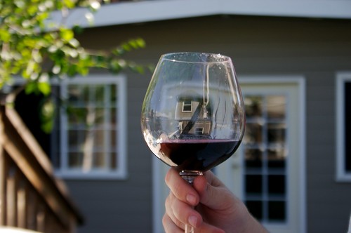 our house reflected in a wineglass