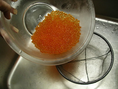 Pouring roe into a sieve