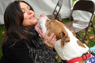 Rachael Ray with adoptable dog giving her a kiss