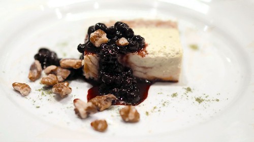 Foraged spruce ricotta cheesecake with a black walnut crust and wild blueberry compote