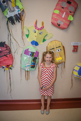 Nora shows off her masks during the art show. • <a style="font-size:0.8em;" href="http://www.flickr.com/photos/96277117@N00/26632853111/" target="_blank">View on Flickr</a>
