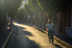 A man cycles through "centro historical" in Mazatlan.