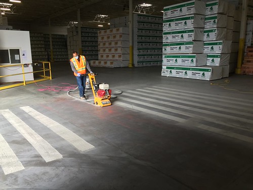 Traction addition to floor to prevent wet tire on forklifts from slipping.