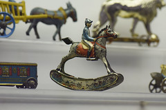 Antique tin toy jockey on rocking horse