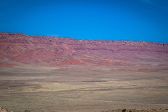 The huge red cliffs surrounded as we rode across the plateau