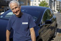 0529 Jonathan smiles with BBC shirt in front of Model X