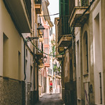 Girl biking through the narrow streets of Palma de Mallorca