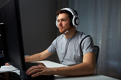 Man in headset playing computer video ga by nodstrum, on Flickr