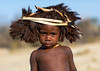 Cute mucubal tribe boy wearing a fur headwear, Namibe Province, Virei, Angola