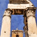 The Tabularium building peeking through the columns of the Temple of Vespasian and Titus, Roman Forum, Italy