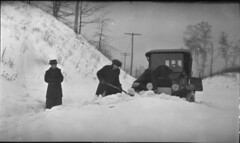 Digging an automobile out of a snow drift on Jane Street, Toronto, Ontario / Un homme déterrant une automobile d’un banc de neige sur la rue Jane, Toronto (Ontario)